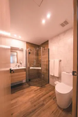 a bathroom with a shower and a toilet and a sink at Fully Serviced Apartment at Regatta Living - 2C in Santo Domingo