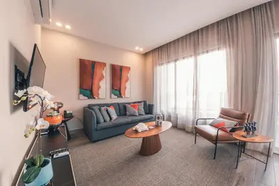a living room with a couch and a table at Fully Serviced Apartment at Regatta Living - 3B in Santo Domingo