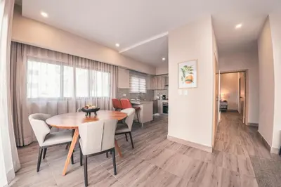 a dining room and kitchen with a table and chairs at Fully Serviced Apartment at Regatta Living - 3B in Santo Domingo