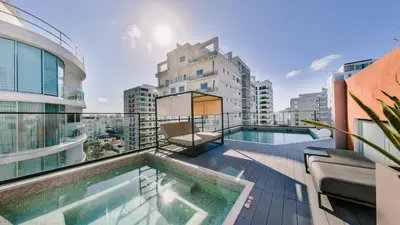 a balcony with a swimming pool on top of a building at Fully Serviced Apartment at Regatta Living II - 703 in La Julia