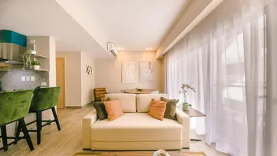 a living room with a white couch and a table at Fully Serviced Apartment at Regatta Living II - 703 in La Julia