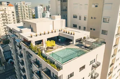 an aerial view of a building with a swimming pool at Fully Serviced Apartment at Regatta Living - 9F in Santo Domingo