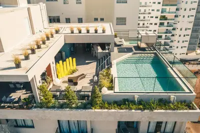an aerial view of a building with a swimming pool at Fully Serviced Apartment at Regatta Living - 9F in Santo Domingo