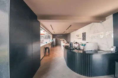 a restaurant with a black counter and a bar at Fully Serviced Apartment at Regatta Living - 9F in Santo Domingo