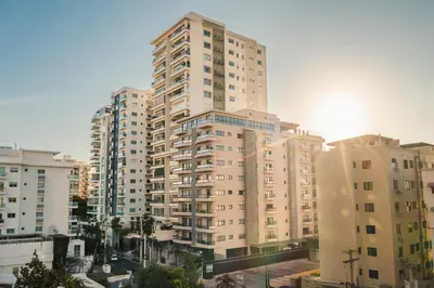 a tall apartment building in a city with buildings at Fully Serviced Apartment at Regatta Living - 9F in Santo Domingo