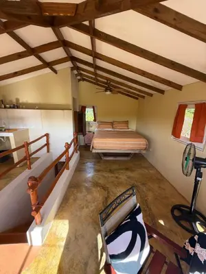 a bedroom with a bed in a room at Yes Papa! Rooms only 100m from the beach! in Las Galeras