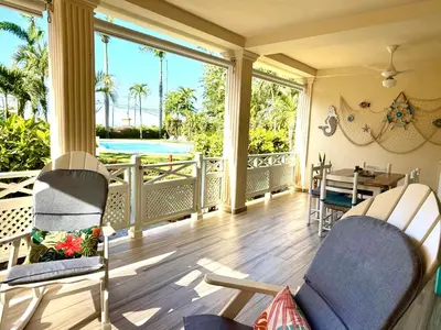 a screened in porch with a table and chairs at La Dolce Vita Beachfront Apt 2 in Las Terrenas