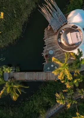 an overhead view of a house on a dock in the water at Green Land Bubble Glamping in Cabarete
