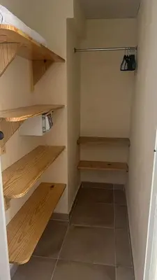 a walk in closet with wooden shelves at Hotel Sea Breeze Sosua in Sosúa