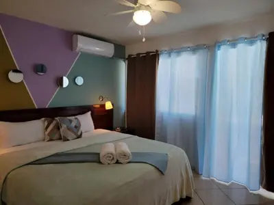 a bedroom with a bed with two towels on it at Hotel Sea Breeze Sosua in Sosúa