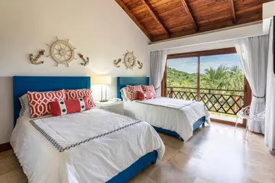 two beds in a room with a balcony at The Greatest 3BR Villa at Puerto Bahia in Los Grini
