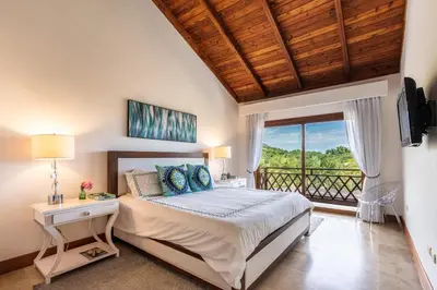 a bedroom with a bed and a balcony at The Greatest 3BR Villa at Puerto Bahia in Los Grini