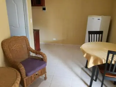 a dining room with a table and a table and chairs at Apartahotel Next Nivel - One bedroom apartment in Punta Cana