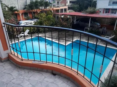 a balcony with a swimming pool in a building at Apartahotel Next Nivel - One bedroom apartment in Punta Cana