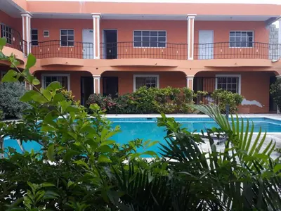 an apartment building with a swimming pool in front of it at Apartahotel Next Nivel - One bedroom apartment in Punta Cana