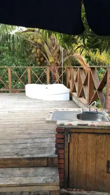 a kitchen with a sink on a wooden deck at VILLA CAMPESTRE EN LOMAS LINDA in Villa Altagracia
