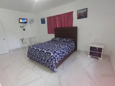a bedroom with a bed in a white room at Apartamento amueblado en Santiago, Res Blue Amber, 2 habitaciones in Santiago de los Caballeros