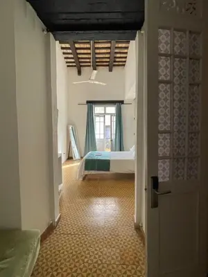 a room with a bedroom with a bed and a window at Mosquito Boutique Hotel Zona Colonial in Santo Domingo