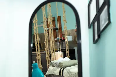 a mirror reflection of a bed in a room at Studio Apartment Center of Sosua Remote Worker Space Fast WiFi in Sosúa