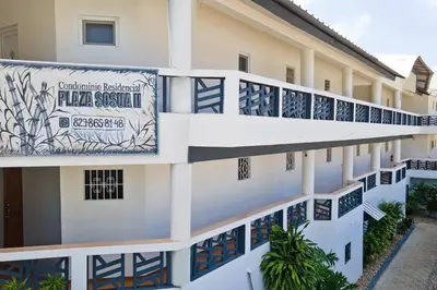 a building with a banner on the side of it at Studio Apartment Center of Sosua Remote Worker Space Fast WiFi in Sosúa