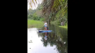 a man on a paddle board in the water at Method Living Tropical Edition 50024 in Cabarete