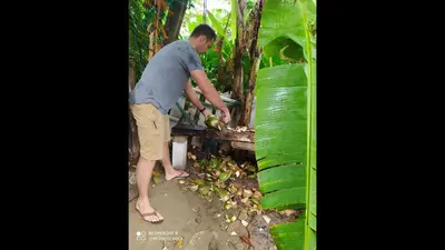 a man is standing next to a table with fruit at Method Living Tropical Edition 50024 in Cabarete