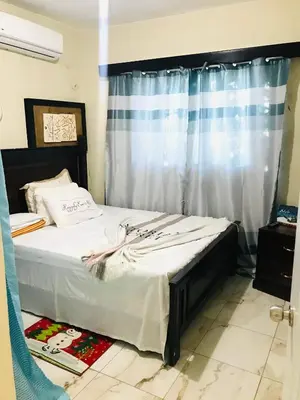 a bed in a room with a window with a bed sidx sidx at En el corazón de la romana con a/c, wifi, luz y gas incluido. in La Romana