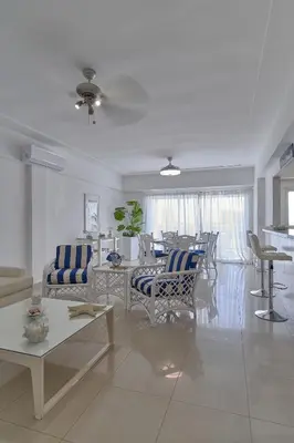 a living room with a couch and chairs and a table at Sunset View 2BR Apartamento Juan Dolio Las Velas in Juan Dolio