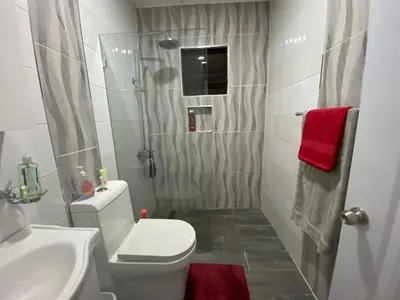 a bathroom with a toilet and a sink and a shower at 6A Cozy Apt in Santiago Center - Great Stay in Santiago de los Caballeros