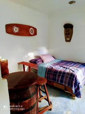 a bedroom with a bed and a table and a chair at Method Living Tropical Edition in Cabarete