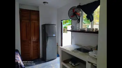 a kitchen with a refrigerator and a sink at Method Living Tropical Edition in Cabarete