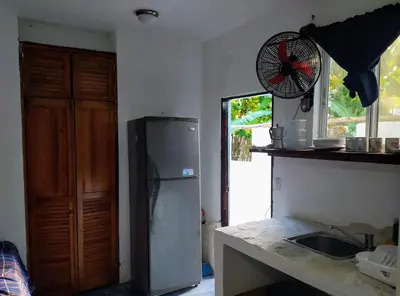 a kitchen with a refrigerator and a sink and a window at Method Living Tropical Edition in Cabarete