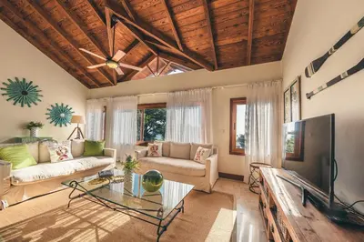 a living room with a couch and a tv at Luxurious Villa at Puerto Bahia with Great Views in Los Grini