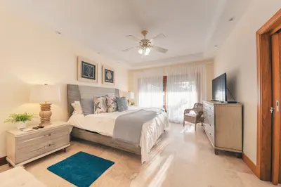 a bedroom with a bed and a flat screen tv at Luxurious Villa at Puerto Bahia with Great Views in Los Grini