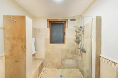 a bathroom with a shower with a glass door at Luxurious Villa at Puerto Bahia with Great Views in Los Grini