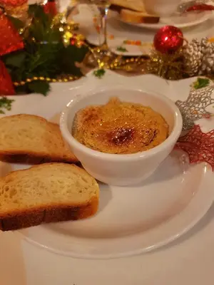 a white plate with a bowl of food and bread at Las Puertas del Paraíso in Río San Juan