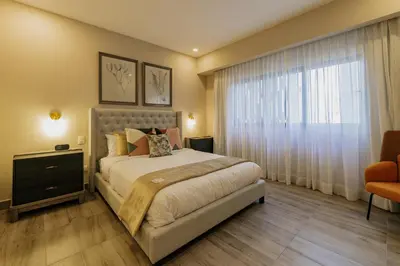 a bedroom with a large bed and a window at Regatta Living Hotel By Mint in Santo Domingo