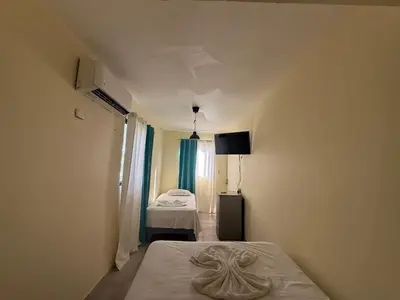 a room with a bed and a bedroom with a bed sidx sidx sidx at Hotel Sol Azul in La Romana