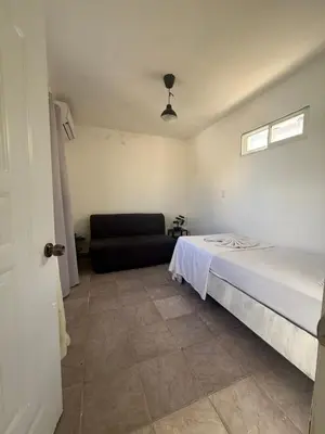 a bedroom with a bed and a couch at Hotel Sol Azul in La Romana