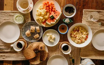 a table with plates of food and cups of coffee at Taino Beach Lofts in El Valle