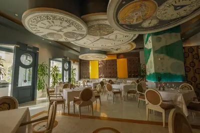 a restaurant with white tables and chairs and ceilings at JOIA Bavaro by Iberostar - Adults Only All Inclusive Resort in Punta Cana