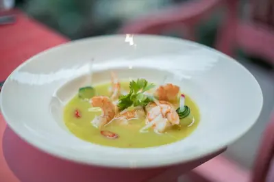 a person holding a white plate of food with shrimp at Iberostar Waves Dominicana - All Inclusive in Punta Cana