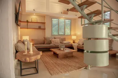 a living room with a couch and a table at Tropical Penthouse in the Heart of Las Terrenas! in Las Terrenas