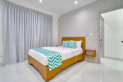 a bedroom with a bed and a large window at Monaco Residences Piantini in Santo Domingo