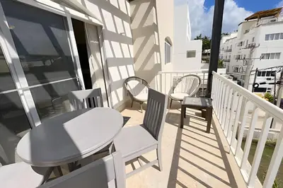 a balcony with chairs and a table on a building at Beach Residence | Escapada Penthouse Vista Mar in Punta Cana