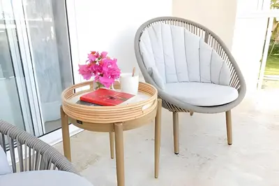 a chair and a table with a vase of flowers at Beach Residence | Escapada Penthouse Vista Mar in Punta Cana