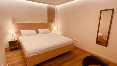 a small bedroom with a bed and a mirror at Hotel La Colonia in Santo Domingo
