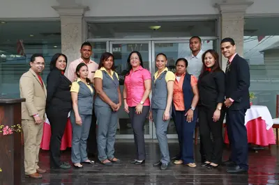 a group of people standing in front of a building at Hotel Los Jardines in Santiago de los Caballeros