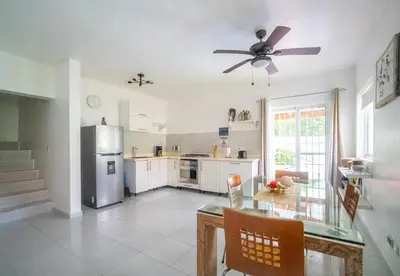 a kitchen with a table and a ceiling fan at Villa Pauline in Bayahibe