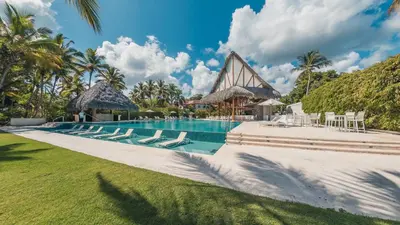 a swimming pool with lounge chairs and a resort at 3BR apartment with balcony in Portillo - Terrenas in Abra Grande